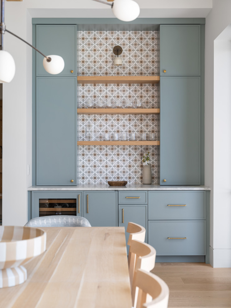 Example of a beach style home bar design in Charleston