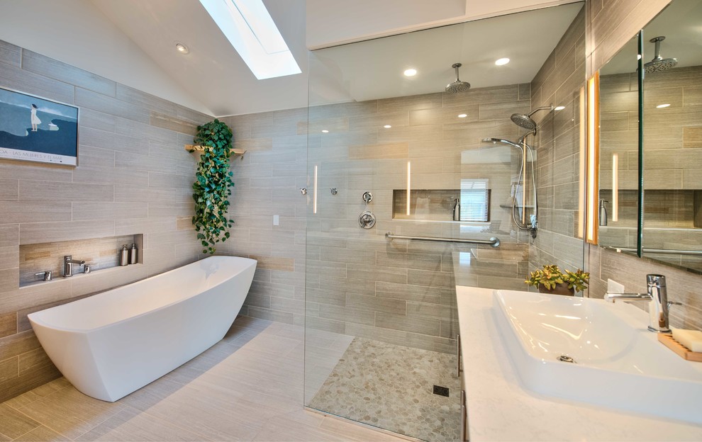 Design ideas for a large contemporary master bathroom in Other with flat-panel cabinets, light wood cabinets, a freestanding tub, a curbless shower, a two-piece toilet, gray tile, ceramic tile, white walls, ceramic floors, a vessel sink, engineered quartz benchtops, grey floor and an open shower.