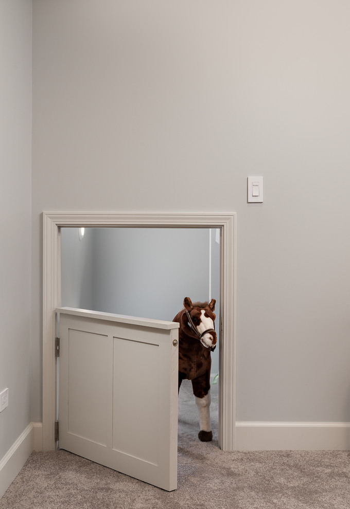 This is an example of a mid-sized transitional kids' room for boys in Chicago with grey walls, carpet and beige floor.