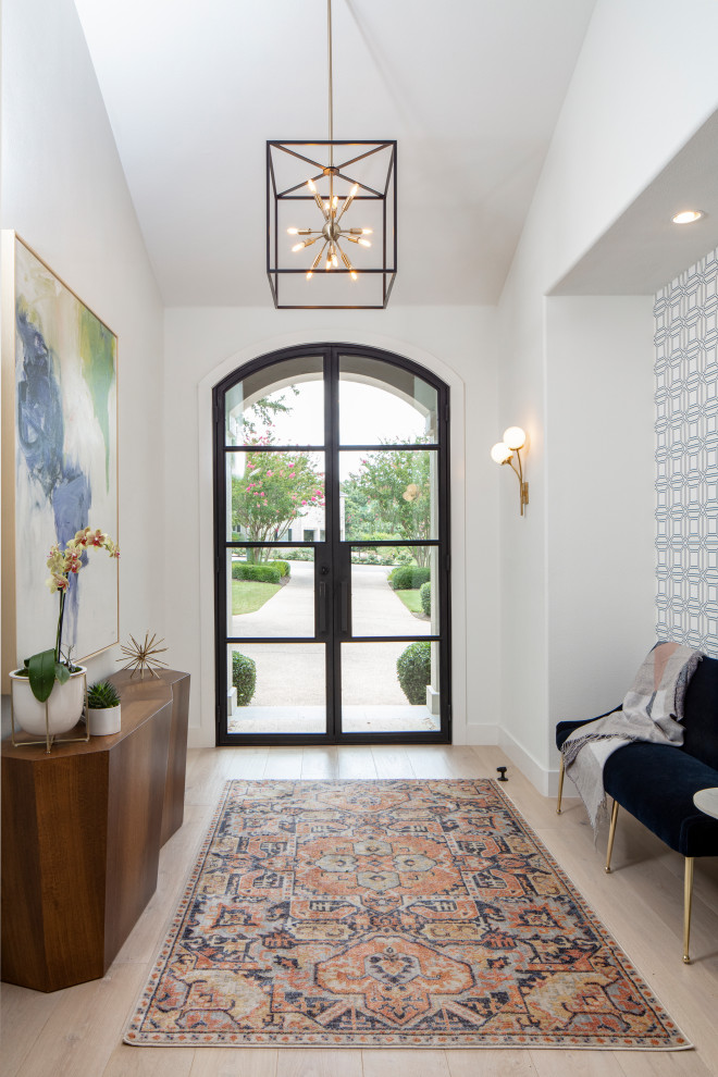 Inspiration for a mid-sized transitional foyer in Austin with white walls, light hardwood floors, a double front door, a glass front door and beige floor.