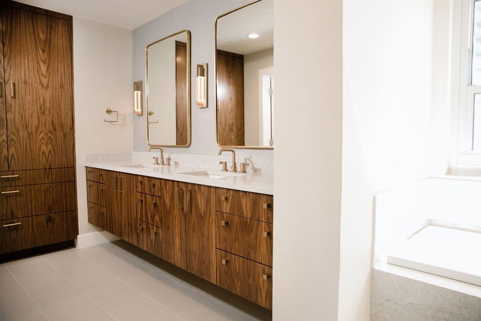 Design ideas for a large midcentury master bathroom in Austin with flat-panel cabinets, brown cabinets, a corner tub, a corner shower, white tile, marble, white walls, a drop-in sink, engineered quartz benchtops, grey floor, a hinged shower door and white benchtops.