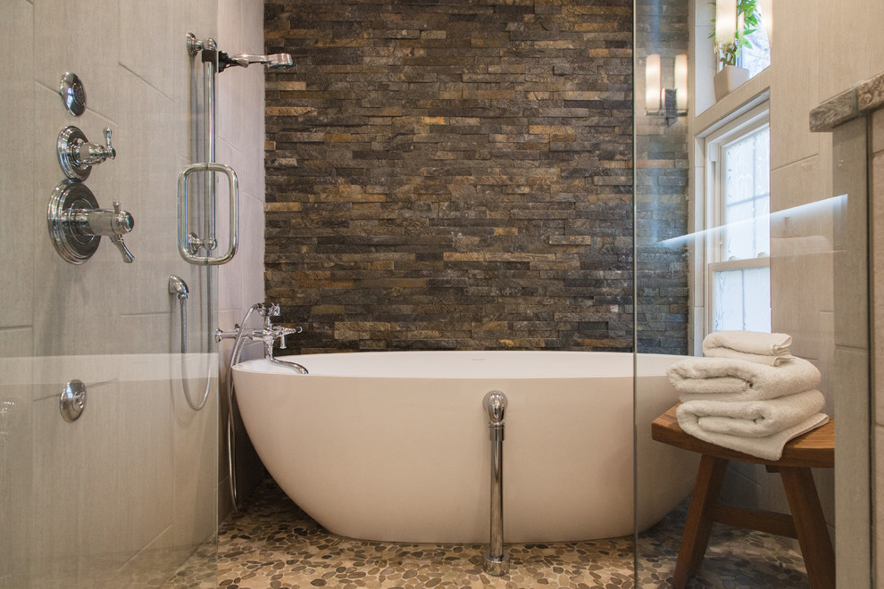 Design ideas for a large contemporary master bathroom in Wichita with flat-panel cabinets, light wood cabinets, a japanese tub, an alcove shower, a two-piece toilet, multi-coloured tile, ceramic tile, beige walls, ceramic floors and a vessel sink.