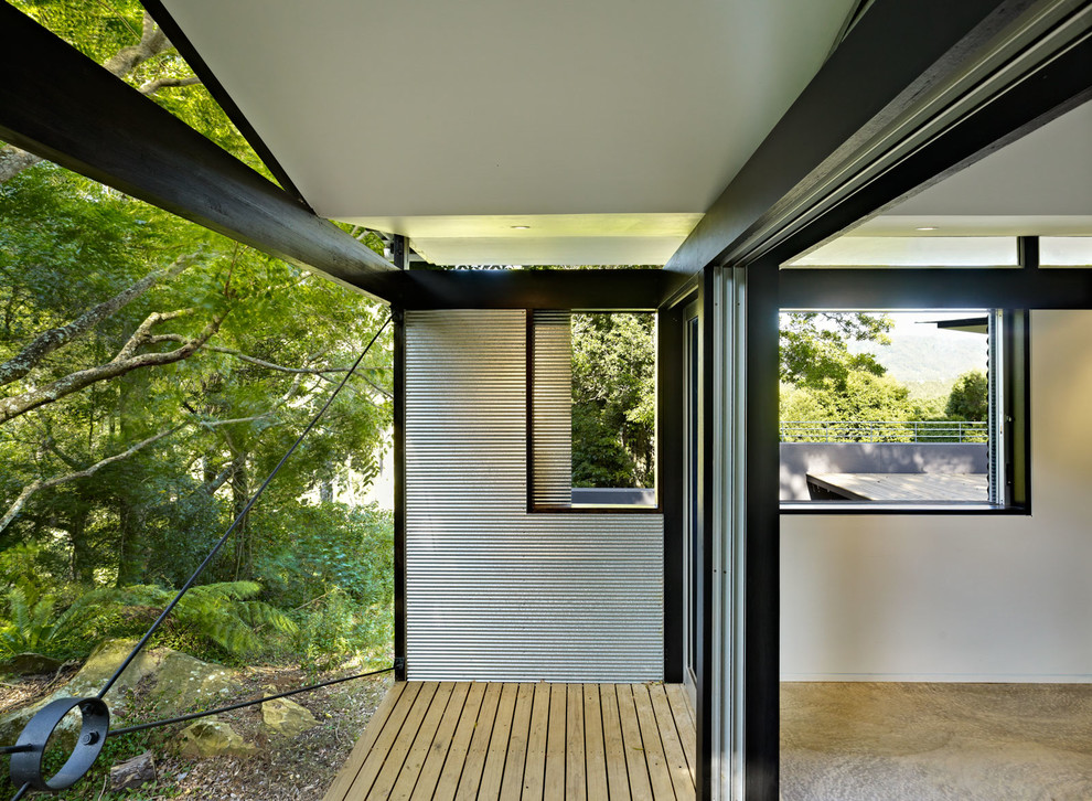 Mid-sized modern patio in Sydney with decking and a roof extension.