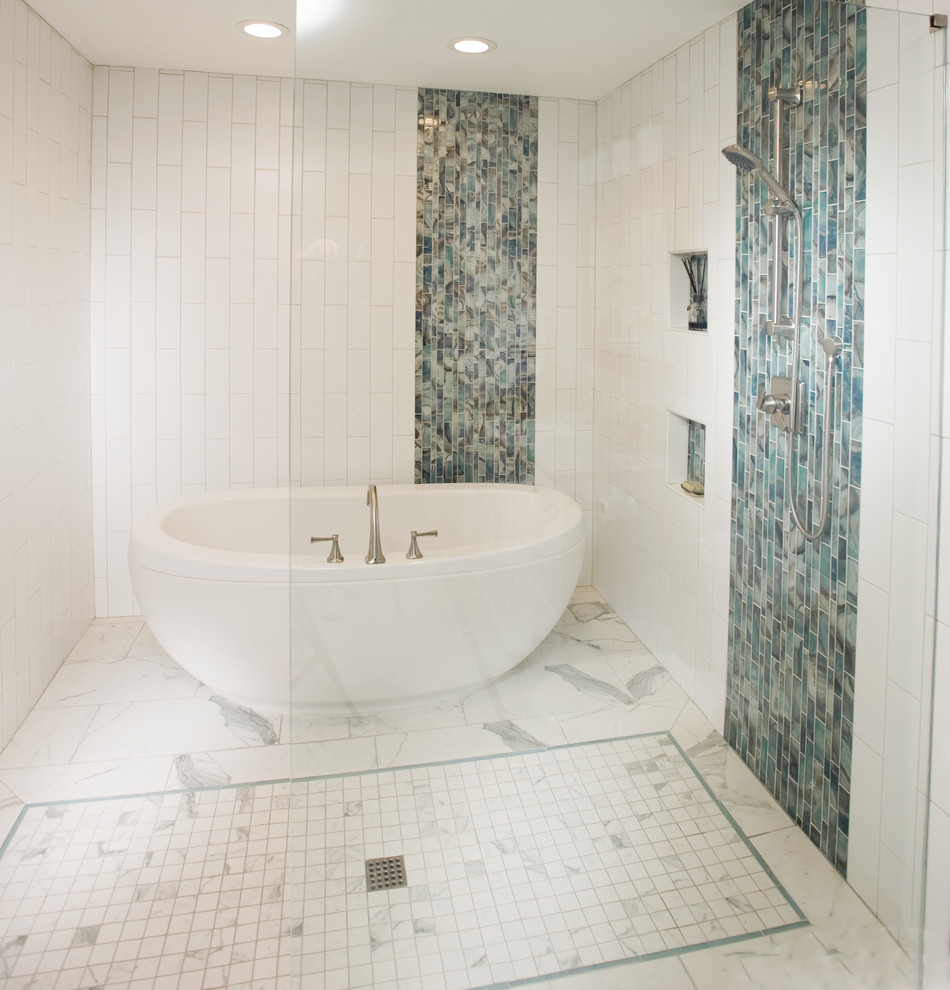 Mid-sized transitional master bathroom in Wichita with raised-panel cabinets, white cabinets, a freestanding tub, an open shower, a two-piece toilet, white tile, blue tile, multi-coloured tile, glass tile, grey walls, porcelain floors, an undermount sink, engineered quartz benchtops, white floor and an open shower.