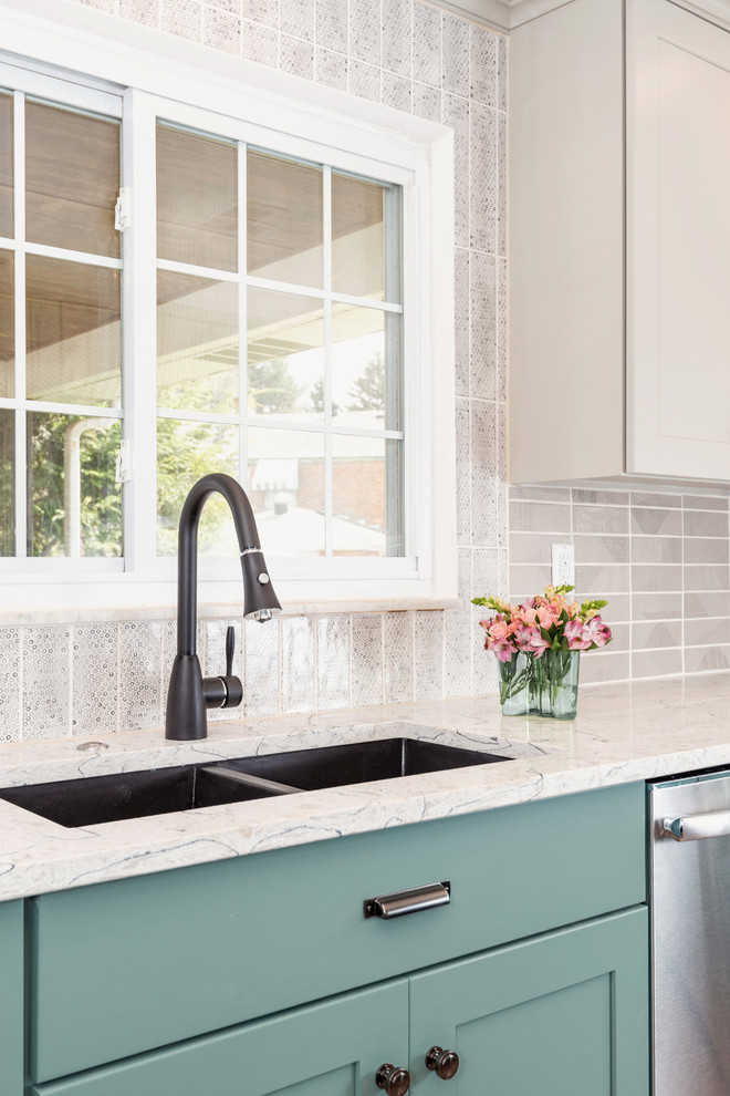 Inspiration for a transitional u-shaped medium tone wood floor and brown floor enclosed kitchen remodel with an undermount sink, shaker cabinets, turquoise cabinets, quartzite countertops, gray backsplash, porcelain backsplash, stainless steel appliances, a peninsula and white countertops