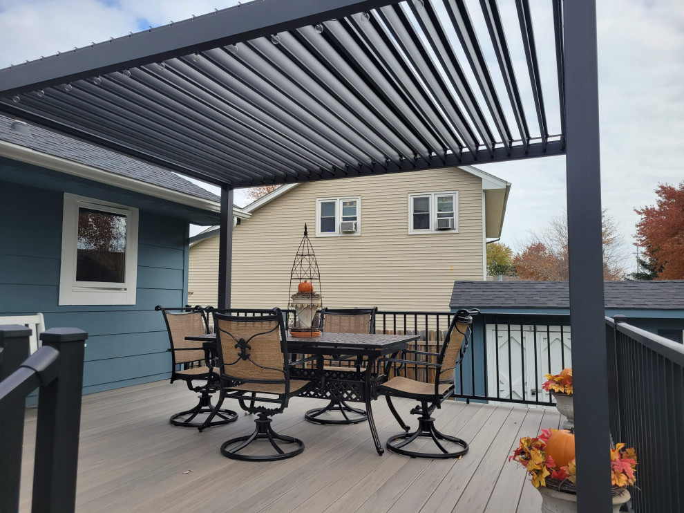 Inspiration for a large backyard ground level metal railing deck remodel with a pergola