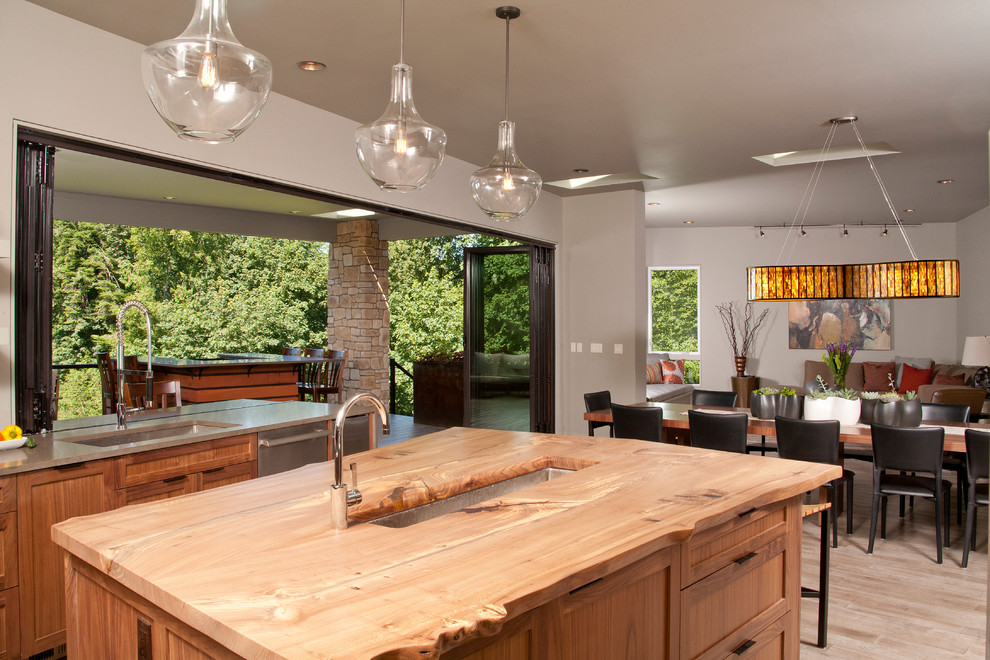 This is an example of a transitional kitchen in Seattle with wood benchtops.