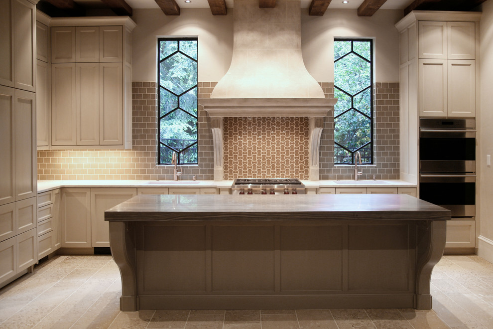 Design ideas for a traditional kitchen in Atlanta with limestone benchtops, beige splashback, mosaic tile splashback and with island.