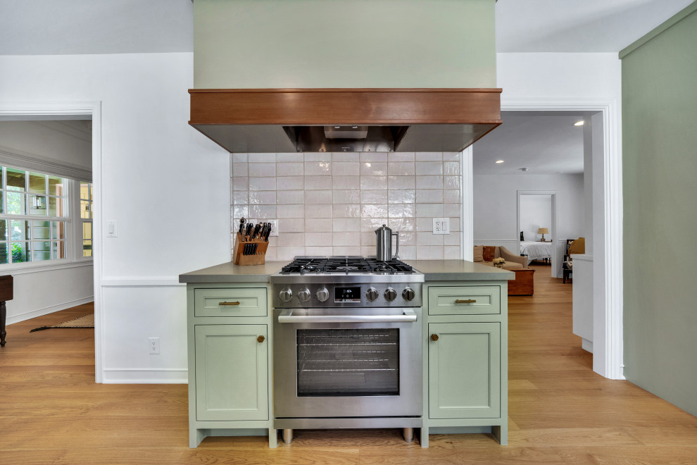 Transitional galley light wood floor eat-in kitchen photo in Los Angeles with a farmhouse sink, recessed-panel cabinets, green cabinets, quartz countertops, beige backsplash, subway tile backsplash, no island and gray countertops