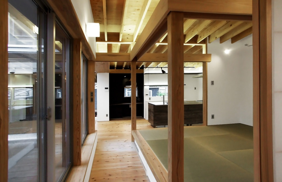 This is an example of a modern hallway in Other with white walls, light hardwood floors, exposed beam and wallpaper.