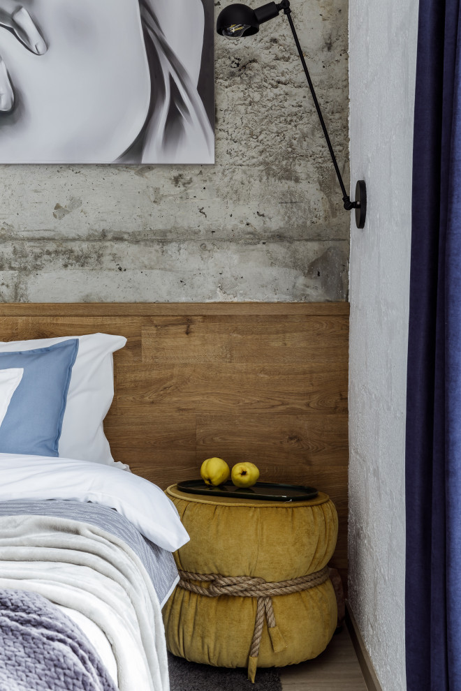 На фото: спальня в белых тонах с отделкой деревом в стиле лофт с серыми стенами, полом из ламината, бежевым полом, панелями на части стены и синими шторами