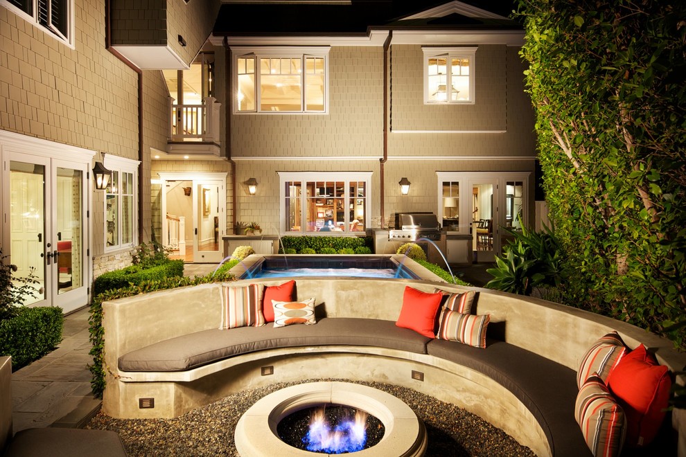 This is an example of a traditional patio in Los Angeles with a fire feature.