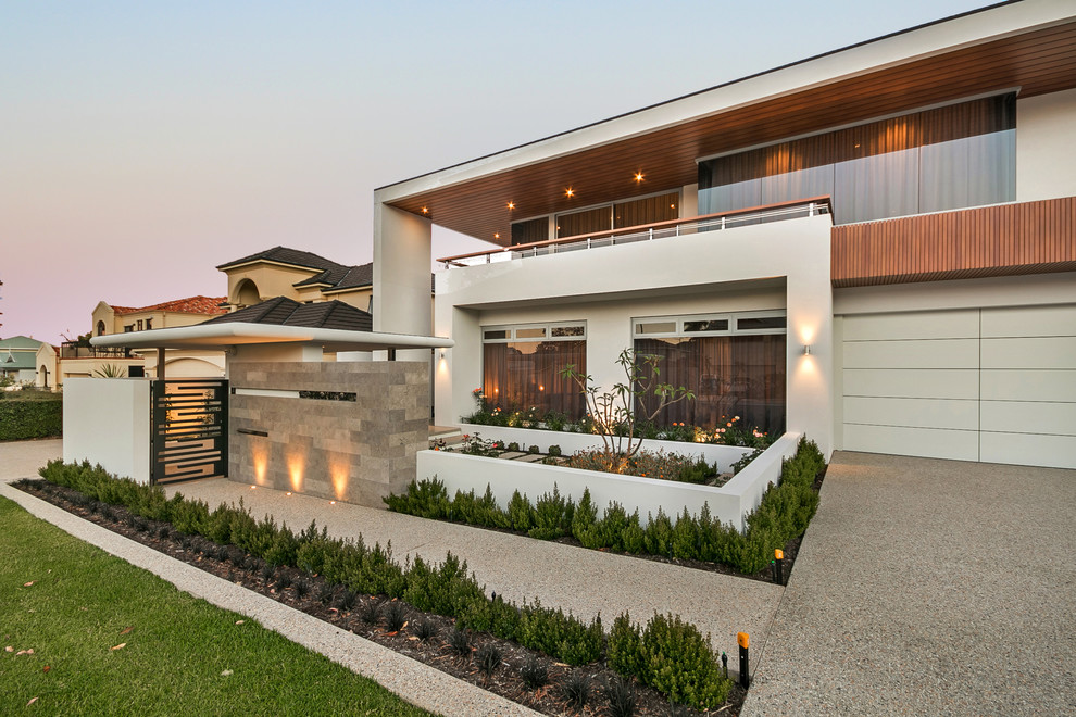 Inspiration for a contemporary two-storey stucco beige house exterior in Perth with a flat roof.