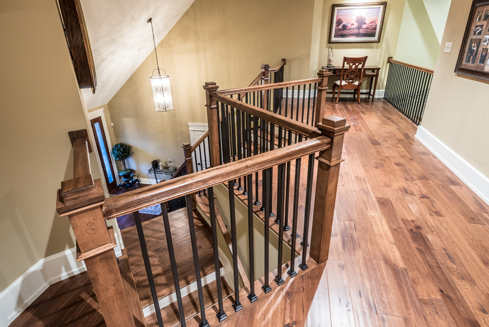 This is an example of a mid-sized country hallway in Other with beige walls, medium hardwood floors and brown floor.