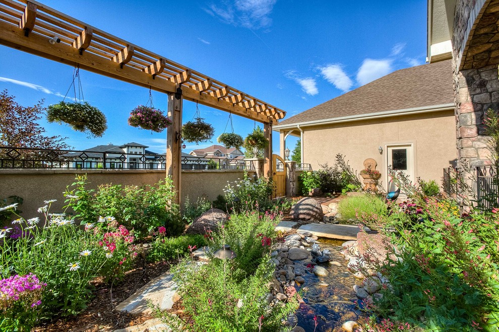 This is an example of a mid-sized transitional partial sun front yard stone walkway in Denver.
