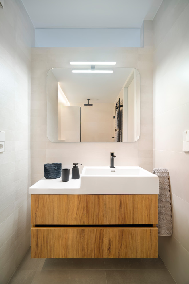Inspiration for a small contemporary bathroom in Other with flat-panel cabinets, white cabinets, beige tile, a wall-mount sink and a built-in vanity.