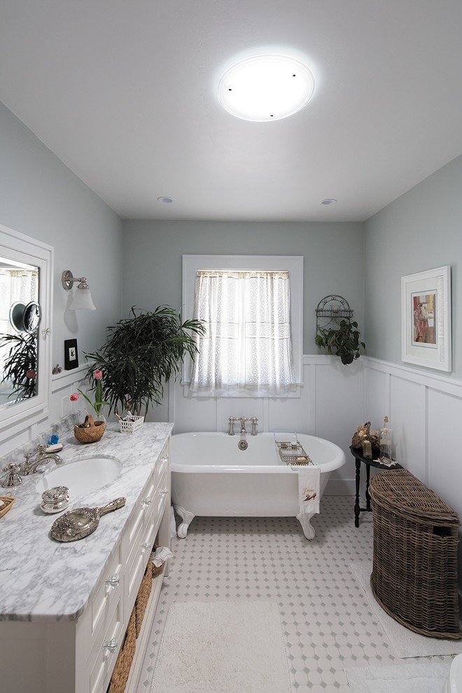 Photo of a small contemporary master bathroom in Austin with a wall-mount sink, open cabinets, white cabinets, marble benchtops, a claw-foot tub, gray tile, glass tile, grey walls and ceramic floors.
