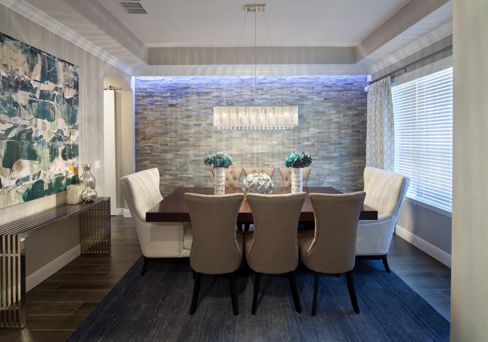This is an example of a mid-sized transitional separate dining room in Orlando with grey walls and porcelain floors.