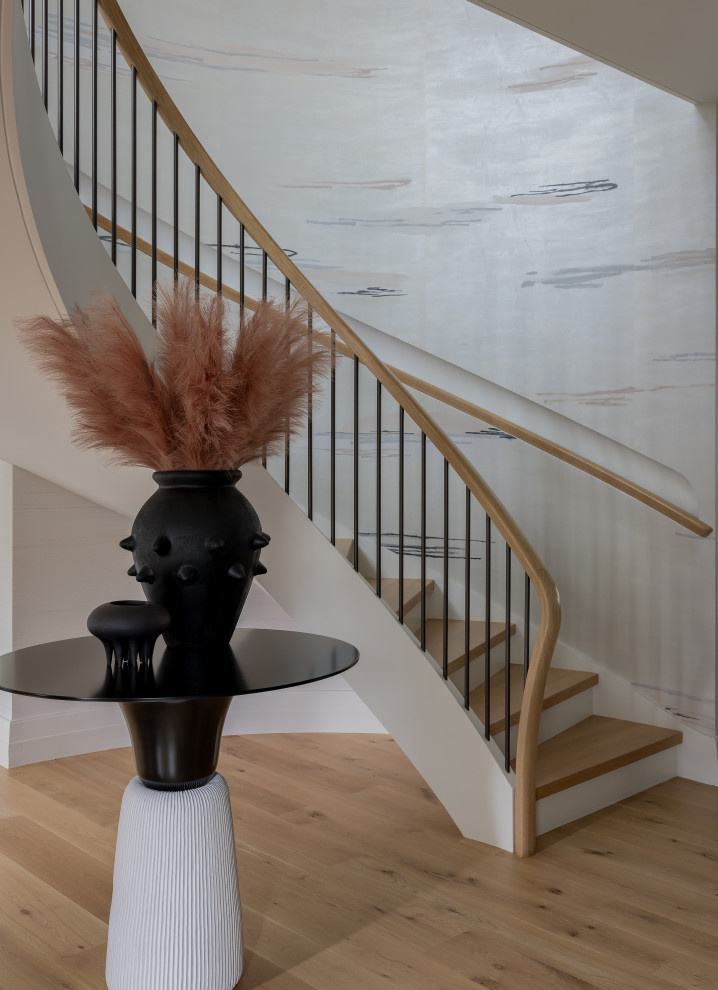 Design ideas for a mid-sized contemporary wood curved staircase in Boston with painted wood risers, wood railing and wallpaper.