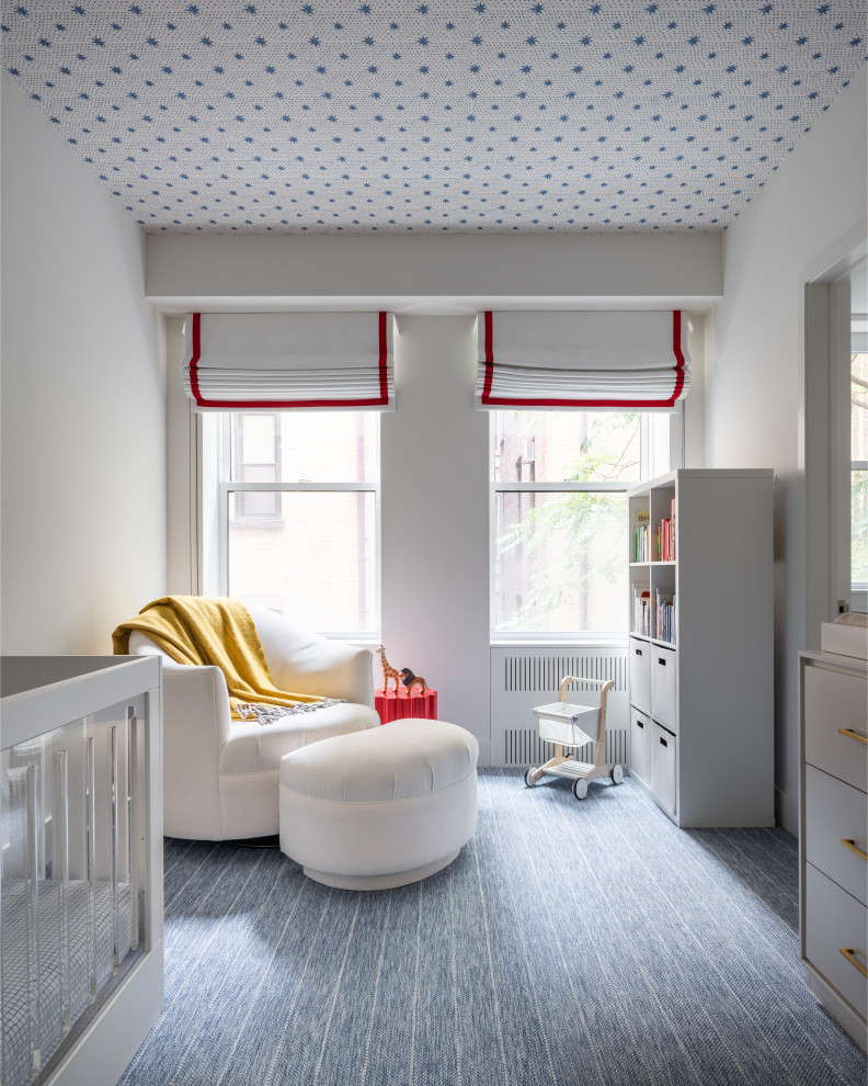 Inspiration for a mid-sized contemporary boy carpeted, blue floor and wallpaper ceiling nursery remodel in New York with white walls