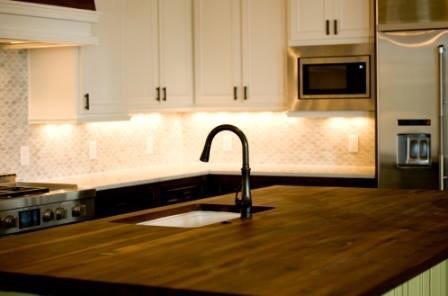 Example of a large transitional l-shaped dark wood floor open concept kitchen design in Austin with an undermount sink, recessed-panel cabinets, white cabinets, marble countertops, gray backsplash, marble backsplash, stainless steel appliances and an island