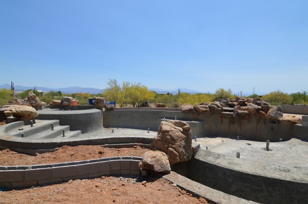 Inspiration for a large timeless backyard infinity pool fountain remodel in Phoenix