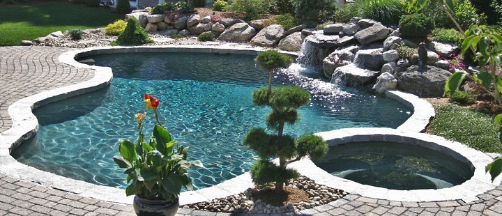 This is an example of a mid-sized modern backyard custom-shaped pool in New York with a water feature and stamped concrete.