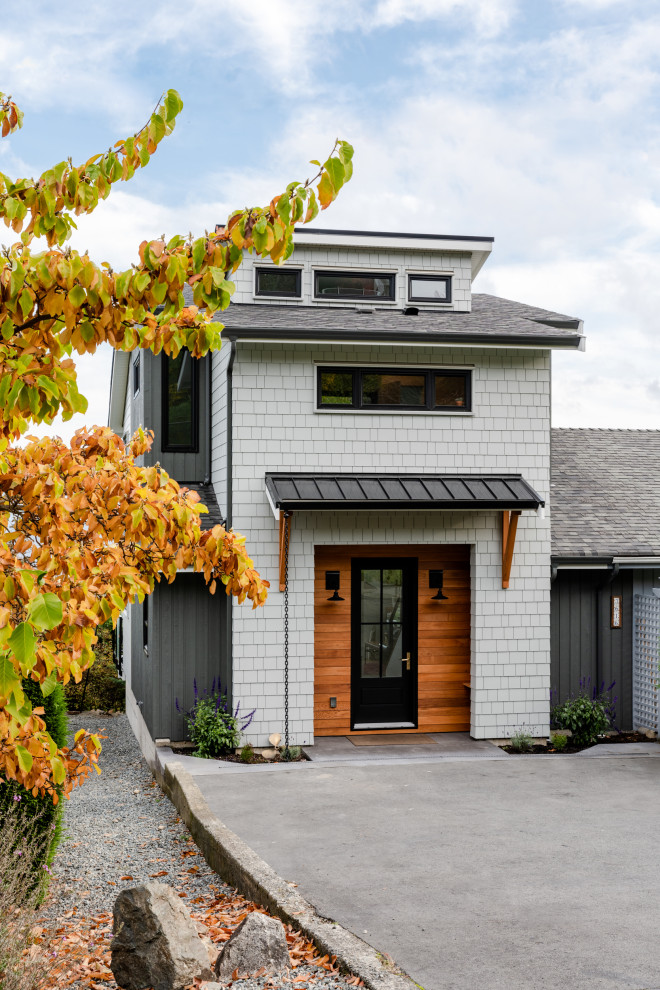 Beach style two-storey grey house exterior in Vancouver with mixed siding, a shed roof, a mixed roof, a grey roof and shingle siding.