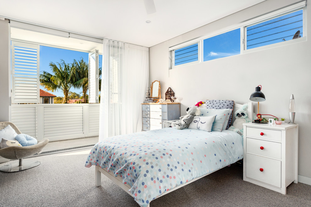 This is an example of a contemporary kids' bedroom for kids 4-10 years old and girls in Newcastle - Maitland with grey walls, carpet and grey floor.
