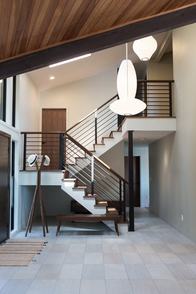 Inspiration for a mid-sized transitional wood l-shaped staircase in Seattle with wood risers and metal railing.