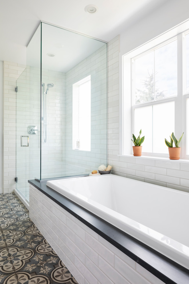 Inspiration for a mid-sized contemporary master bathroom in Seattle with an alcove tub, a corner shower, white tile, subway tile, white walls, porcelain floors, soapstone benchtops, blue floor, a hinged shower door, black benchtops and a shower seat.