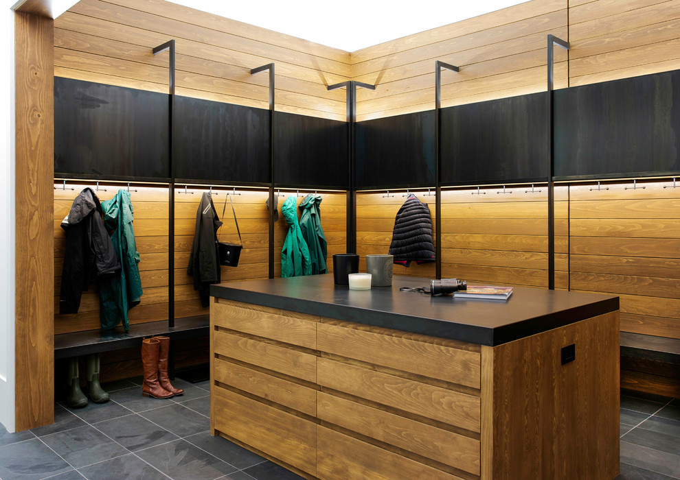 Photo of an expansive contemporary mudroom in Montreal with slate floors and black walls.