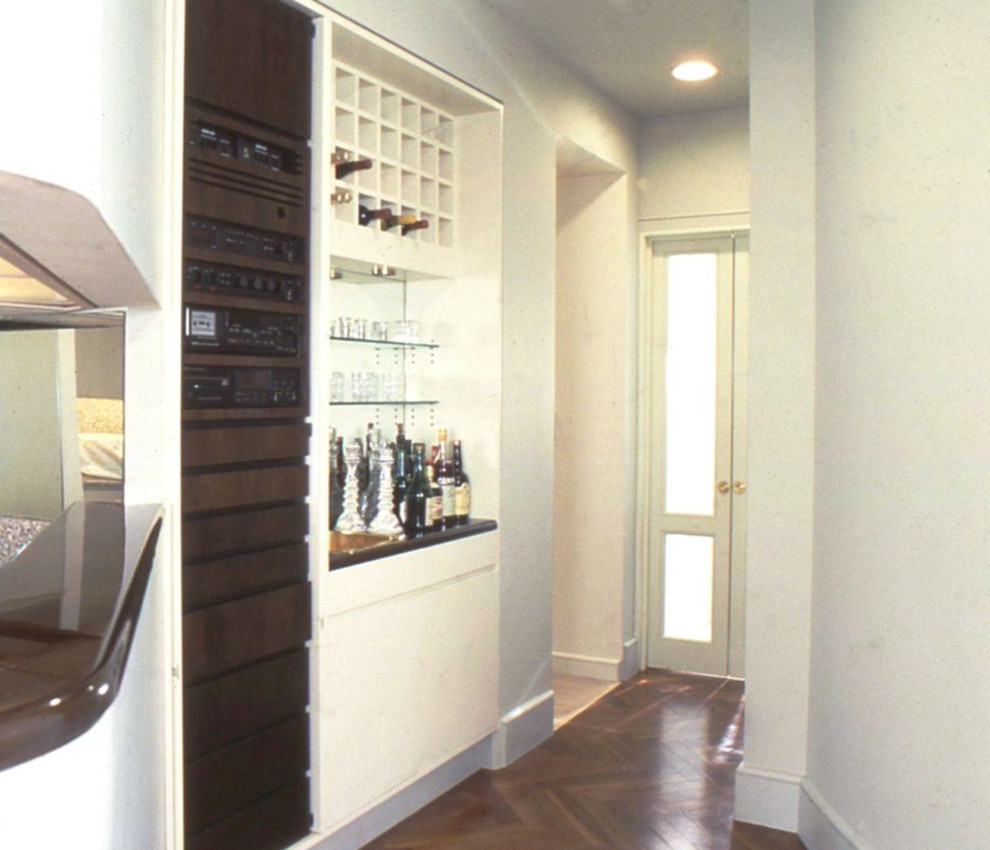 Inspiration for a small transitional hallway in New York with beige walls and dark hardwood floors.
