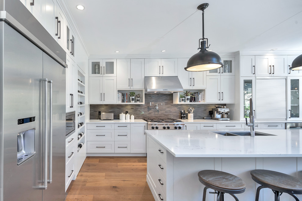 Example of a transitional l-shaped medium tone wood floor and brown floor kitchen design