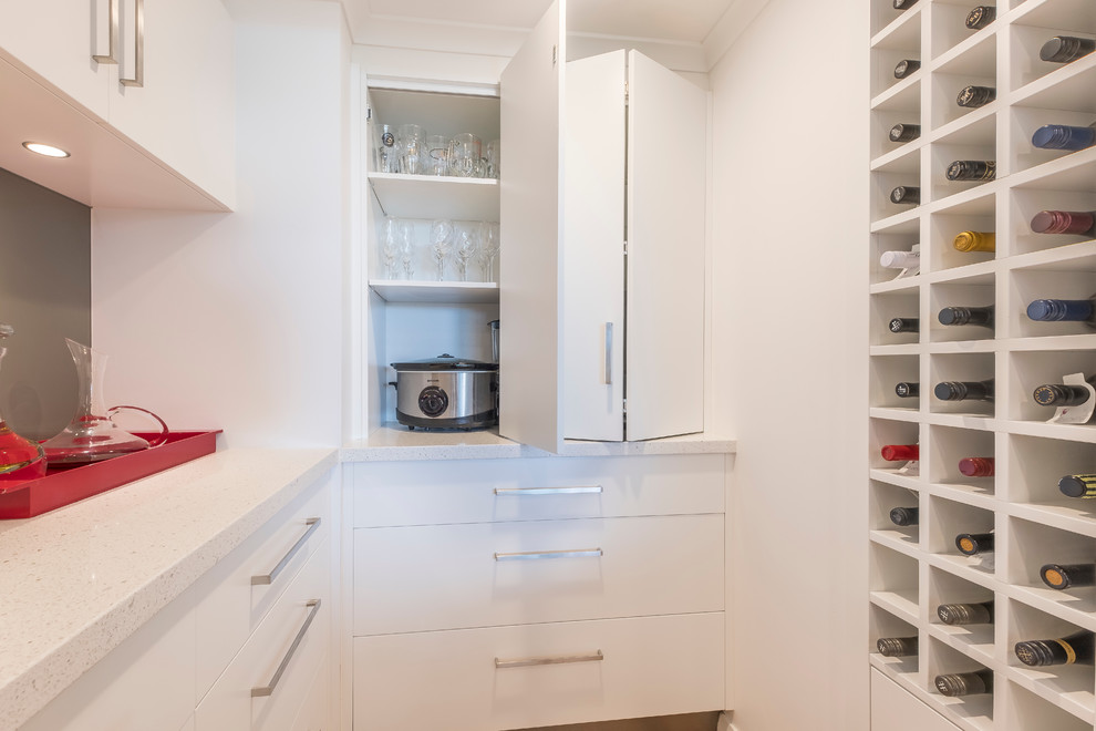 Contemporary kitchen in Perth with flat-panel cabinets, white cabinets, quartz benchtops, grey splashback, glass sheet splashback and white benchtop.