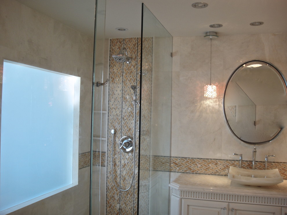 Design ideas for a transitional master bathroom in Miami with a vessel sink, raised-panel cabinets, white cabinets, marble benchtops, a curbless shower, a wall-mount toilet, white tile, stone tile, multi-coloured walls and marble floors.