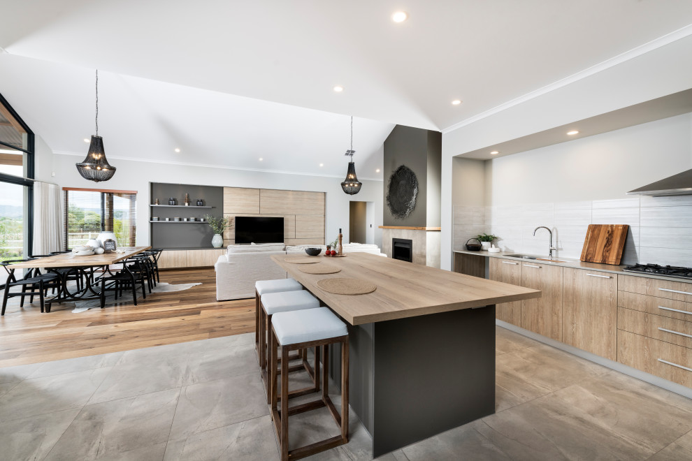 Design ideas for a large country galley open plan kitchen in Perth with a drop-in sink, flat-panel cabinets, light wood cabinets, wood benchtops, white splashback, ceramic splashback, stainless steel appliances, ceramic floors, with island and brown floor.