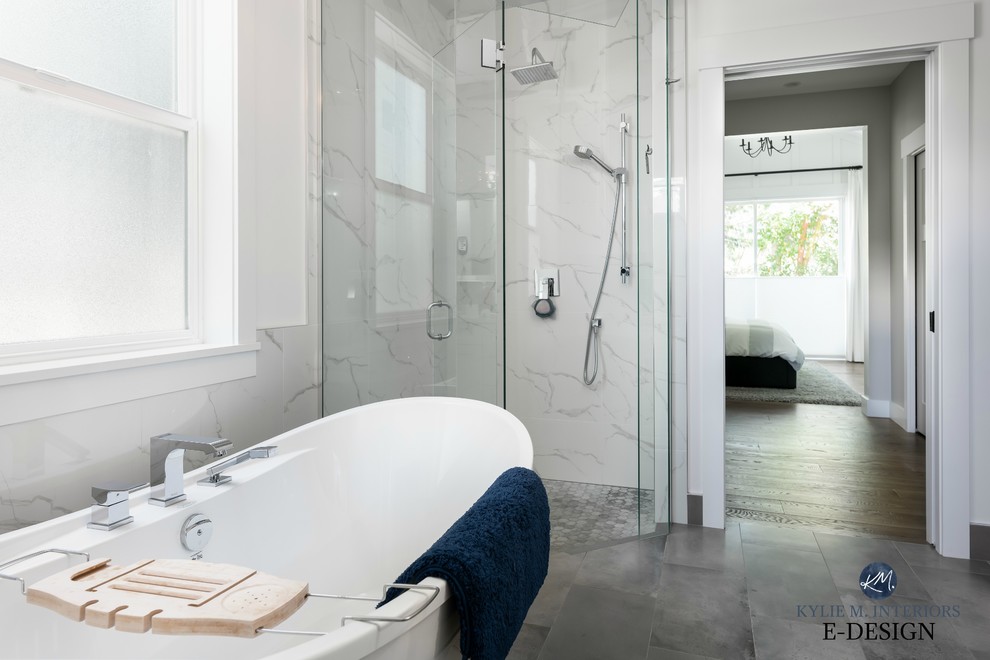 Inspiration for a mid-sized transitional master bathroom in Vancouver with shaker cabinets, white cabinets, a freestanding tub, a corner shower, gray tile, porcelain tile, white walls, porcelain floors, an undermount sink, engineered quartz benchtops, grey floor, a hinged shower door and white benchtops.