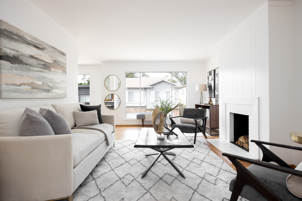 This is an example of a mid-sized modern formal open concept living room in San Francisco with white walls, medium hardwood floors, a brick fireplace surround and yellow floor.