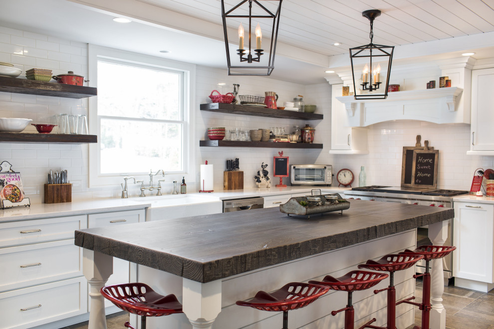 Inspiration for a large country l-shaped porcelain tile, gray floor and coffered ceiling eat-in kitchen remodel in New York with a farmhouse sink, recessed-panel cabinets, white cabinets, concrete countertops, white backsplash, ceramic backsplash, stainless steel appliances and gray countertops