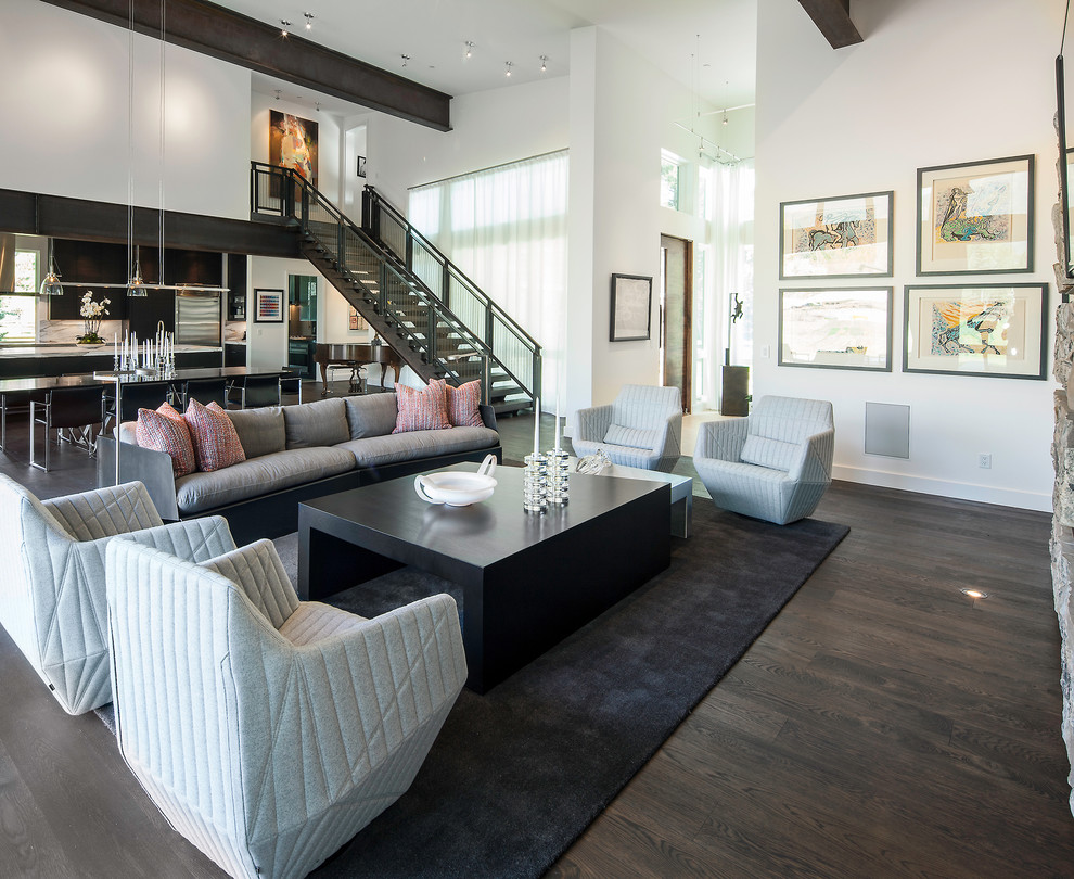 This is an example of a contemporary open concept living room in Salt Lake City with white walls and brown floor.