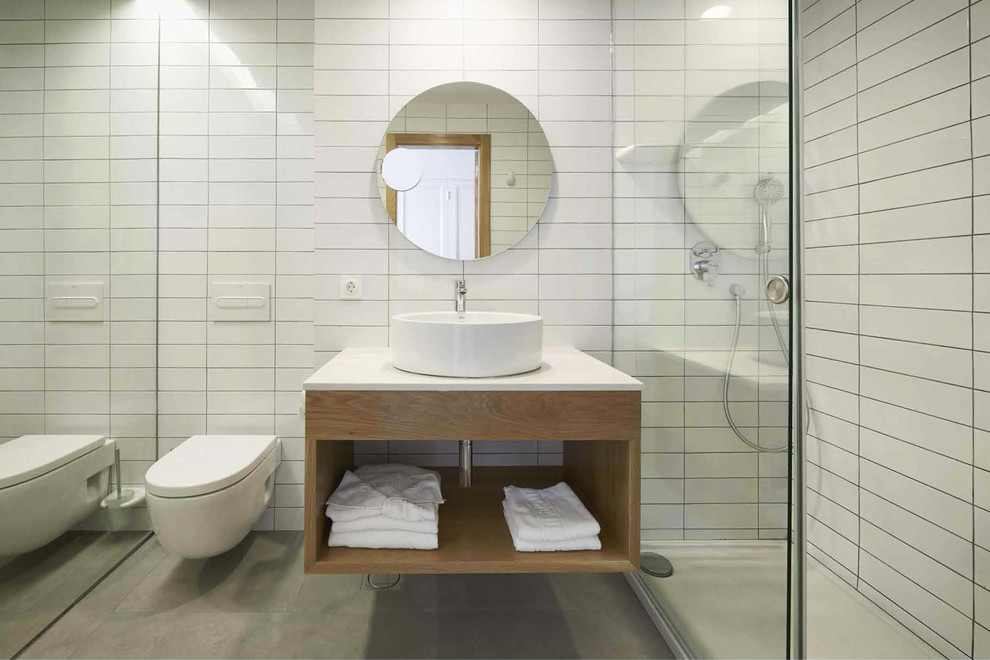Inspiration for a mid-sized scandinavian 3/4 bathroom in Other with open cabinets, medium wood cabinets, a curbless shower, a wall-mount toilet, a vessel sink and white walls.