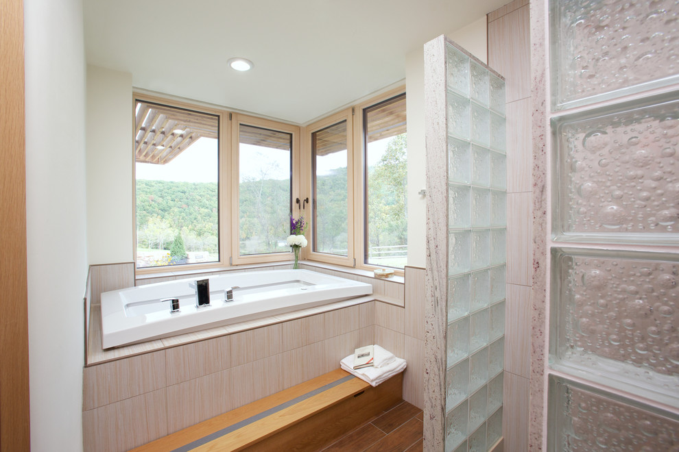 Design ideas for a contemporary master bathroom in Portland Maine with an alcove shower, a drop-in tub, beige tile and white walls.