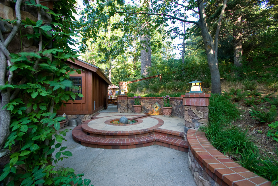 This is an example of an arts and crafts backyard patio in Los Angeles with a water feature and no cover.