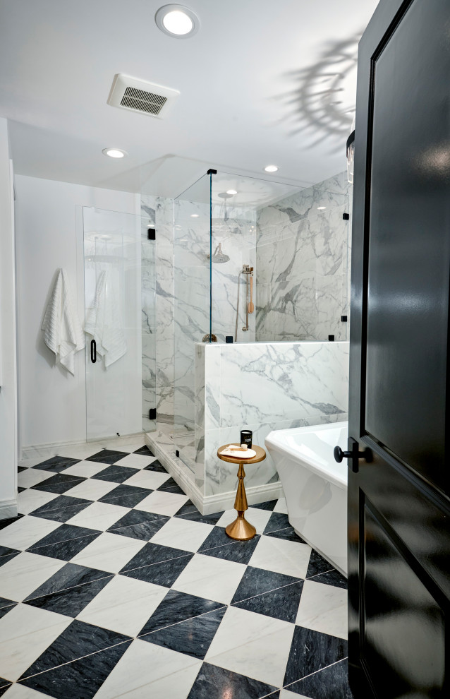 This is an example of an expansive traditional ensuite bathroom in Denver with recessed-panel cabinets, white cabinets, a freestanding bath, an alcove shower, a one-piece toilet, white tiles, marble tiles, white walls, marble flooring, a submerged sink, engineered stone worktops, black floors, a hinged door, black worktops, a wall niche, a single sink, a freestanding vanity unit and wallpapered walls.