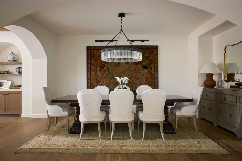 Large tuscan medium tone wood floor and brown floor dining room photo in Los Angeles with white walls