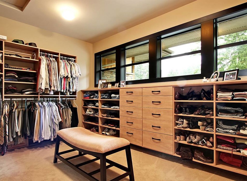 Photo of a large contemporary gender-neutral walk-in wardrobe in Portland with flat-panel cabinets, light wood cabinets, carpet and beige floor.