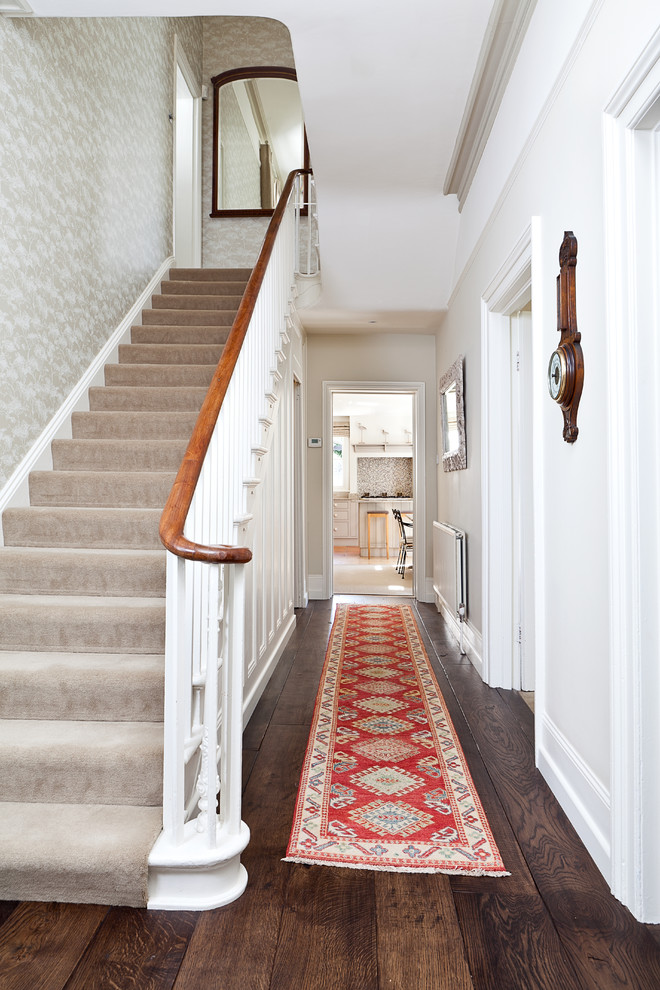 Photo of a traditional hallway in Kent with white walls, dark hardwood floors and brown floor.