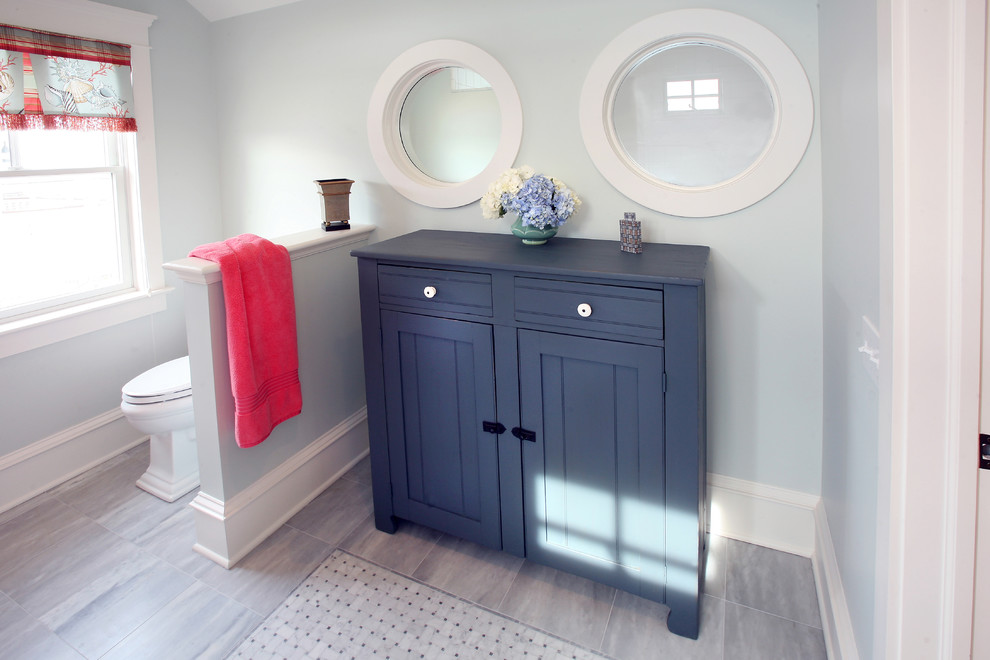 Inspiration for a beach style bathroom in Philadelphia with shaker cabinets and blue cabinets.