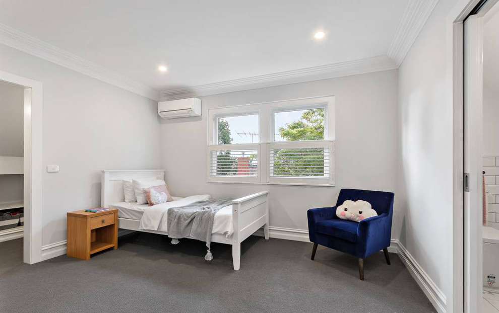 Large traditional loft-style bedroom in Melbourne with white walls, carpet, no fireplace and grey floor.